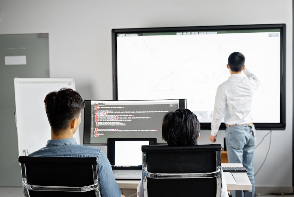 Team conducting a business presentation with technology in a modern office setting