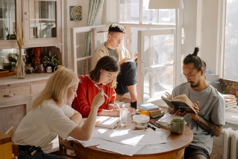 A group of college students studying in a bright, cozy room with natural light